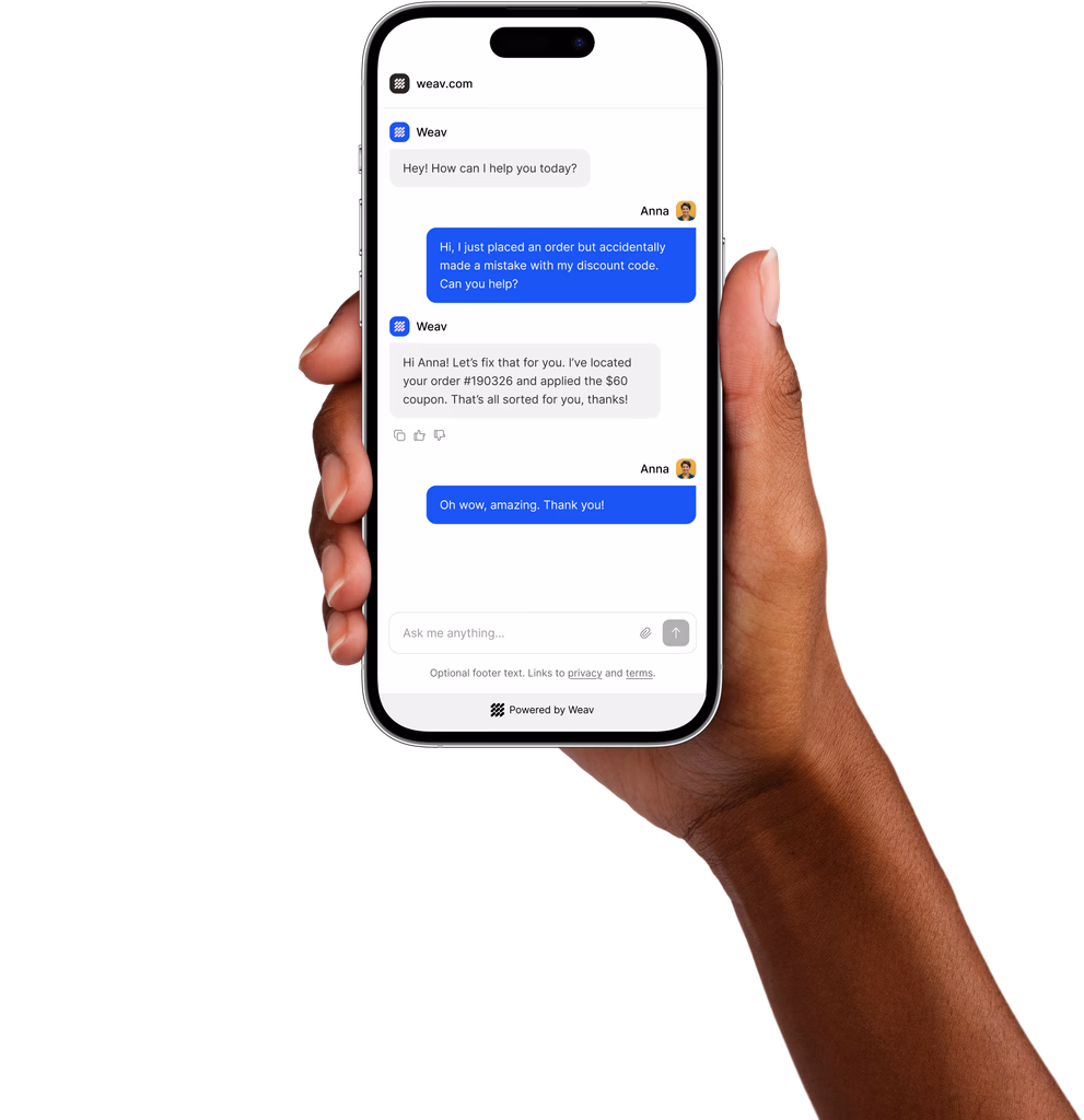 A hand holding a phone with a Storbell chat conversation
